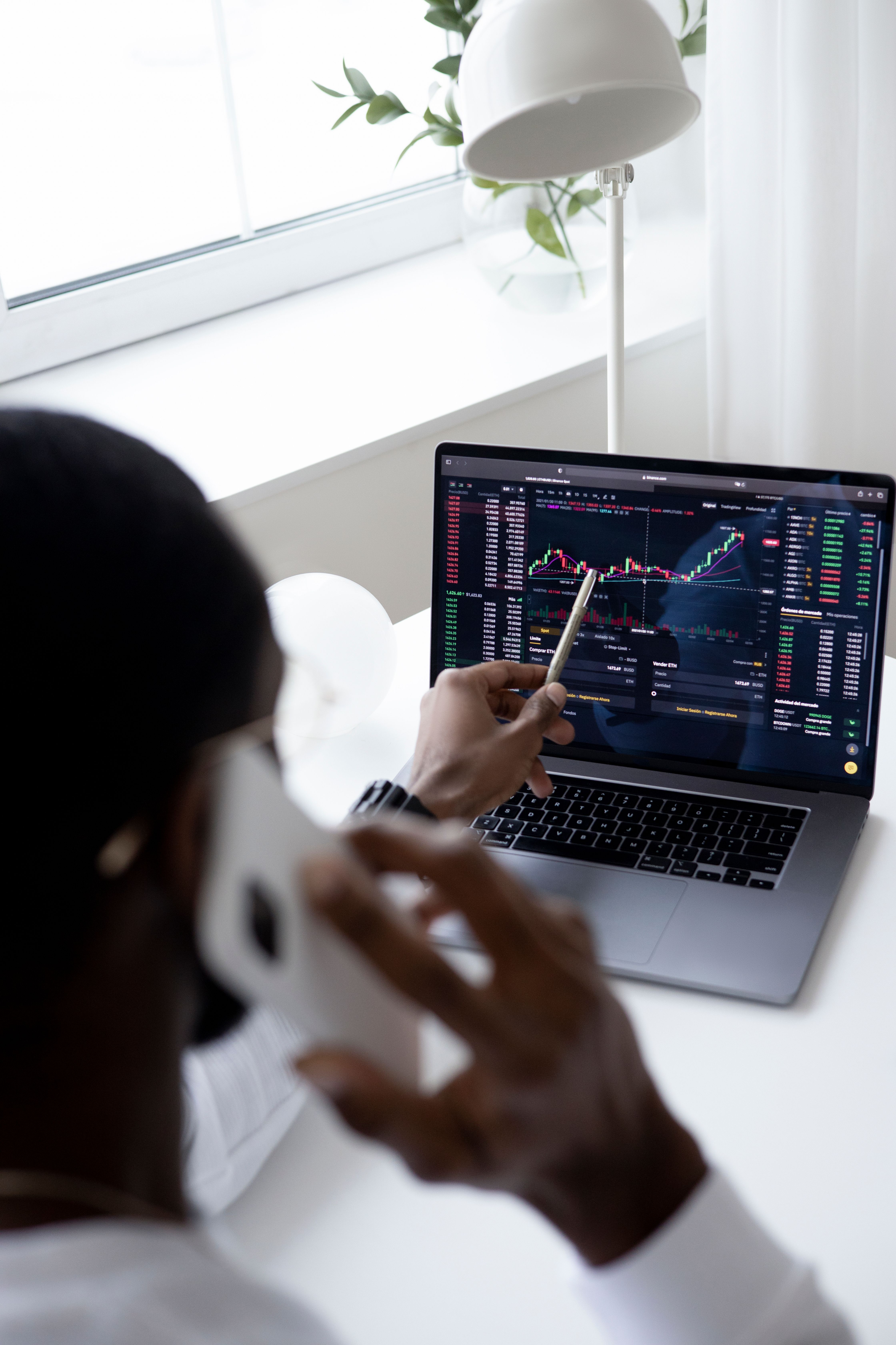 An investor reviewing live market charts on a laptop